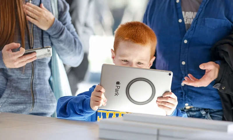 Logan Roe, 7, tries out the augmented reality system that shows what the finished Apple Park will look like at the opening of the Apple Park Visitor Center on November 17, 2017 in Cupertino, California. (Photo by Amy Osborne / AFP) (Photo by AMY OSBORNE/AFP via Getty Images)