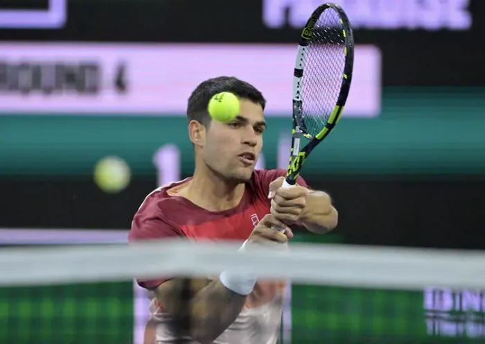 Carlos Alcaraz (ESP) hits a shot as he defeated Grigor Dimitrov (not pictured) in his fourth round match of the BNP Paribas Open at the Indian Well Tennis Garden. Mandatory Credit: Jayne Kamin-Oncea-Imagn Images