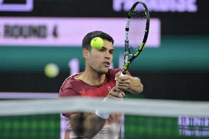 Carlos Alcaraz (ESP) hits a shot as he defeated Grigor Dimitrov (not pictured) in his fourth round match of the BNP Paribas Open at the Indian Well Tennis Garden. Mandatory Credit: Jayne Kamin-Oncea-Imagn Images