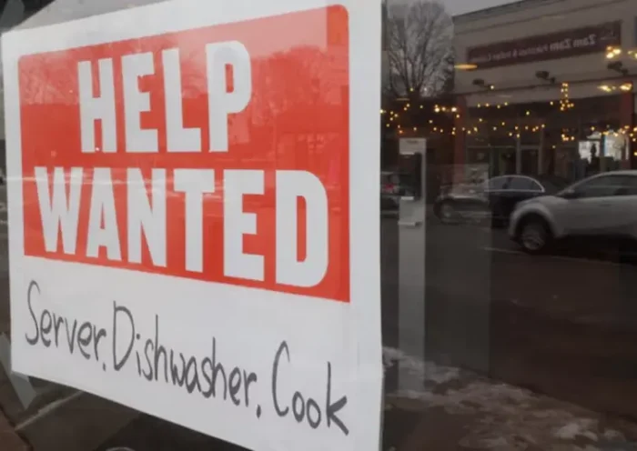 A “Help Wanted” sign hangs in restaurant window in Medford, Massachusetts, U.S., January 25, 2023. REUTERS/Brian Snyder/File Photo