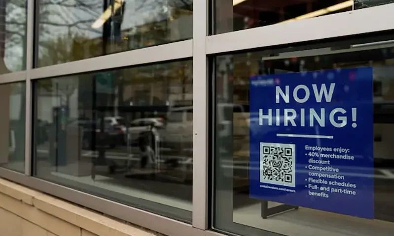 An employee hiring sign with a QR code is seen in a window of a business in Arlington, Virginia, U.S., April 7, 2023. REUTERS/Elizabeth Frantz/ File Photo
