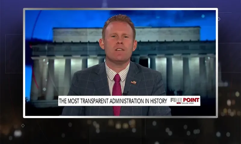 Video still of the host of Fine Point at the desk of their talk show on One America News Network.