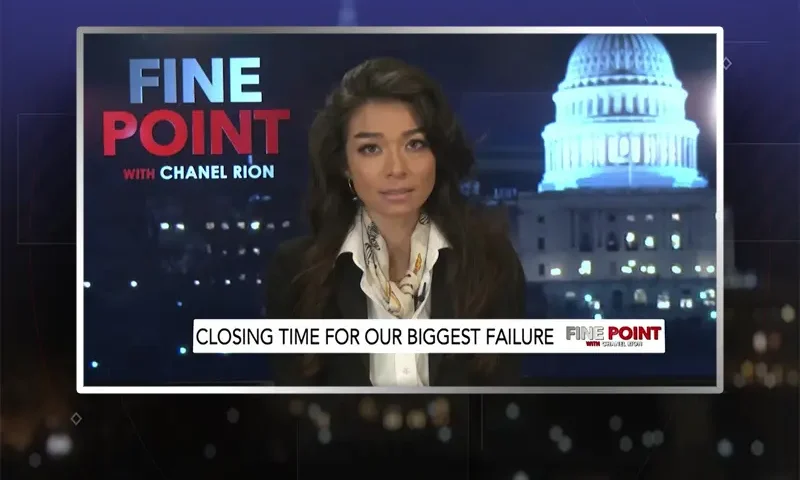 Video still of the host of Fine Point at the desk of their talk show on One America News Network.