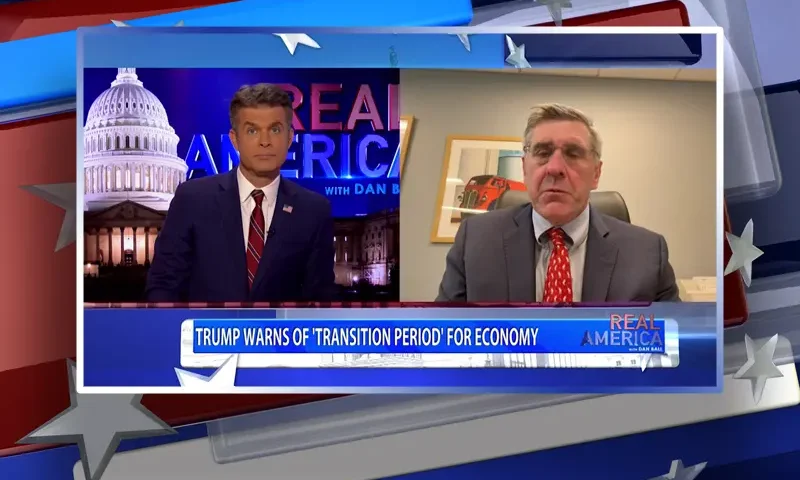 Video still from Real America on One America News Network showing a split screen of the host on the left side, and on the right side is the guest, Steve Moore.