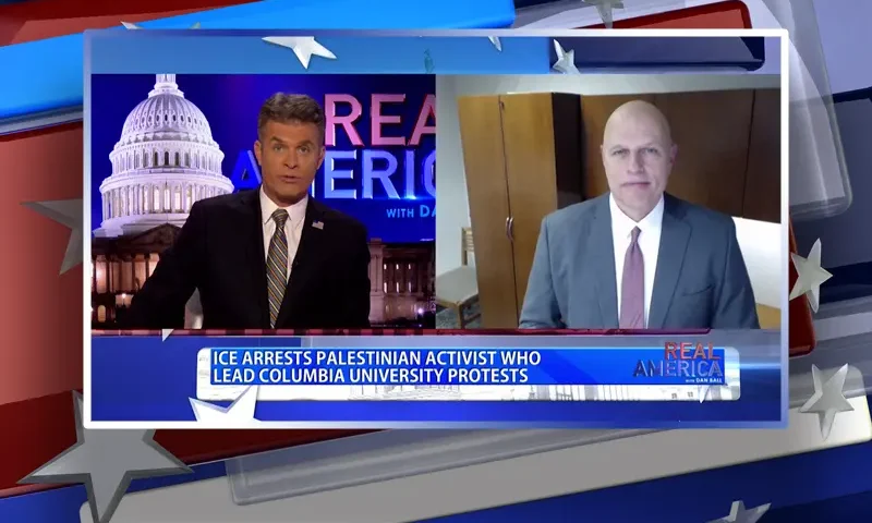 Video still from Real America on One America News Network showing a split screen of the host on the left side, and on the right side is the guest, Ron Vitiello.