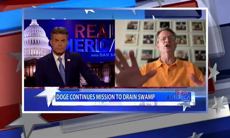 Video still from Real America on One America News Network showing a split screen of the host on the left side, and on the right side is the guest, Tim Burchett.