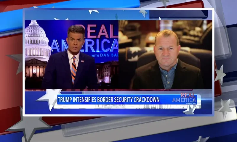 Video still from Real America on One America News Network showing a split screen of the host on the left side, and on the right side is the guest, Troy Nehls.