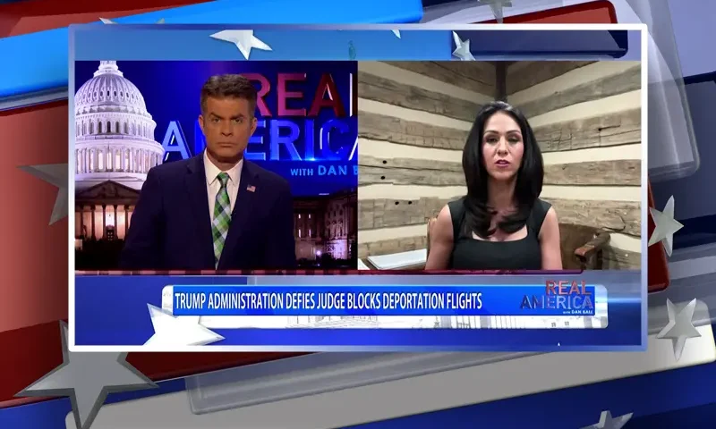 Video still from Real America on One America News Network showing a split screen of the host on the left side, and on the right side is the guest, Rep. Lauren Boebert.