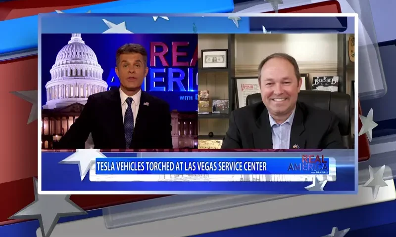 Video still from Real America on One America News Network showing a split screen of the host on the left side, and on the right side is the guest, Marlin Stutzman.