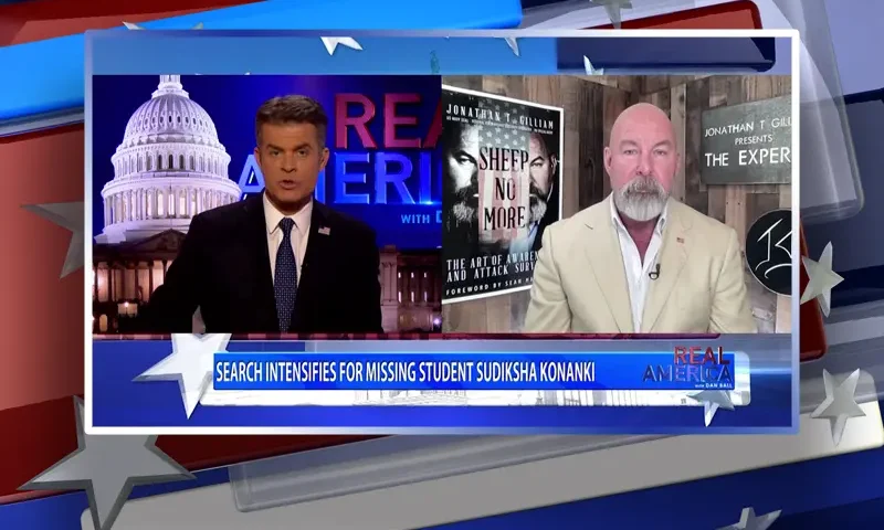 Video still from Real America on One America News Network showing a split screen of the host on the left side, and on the right side is the guest, Jonathan Gilliam.