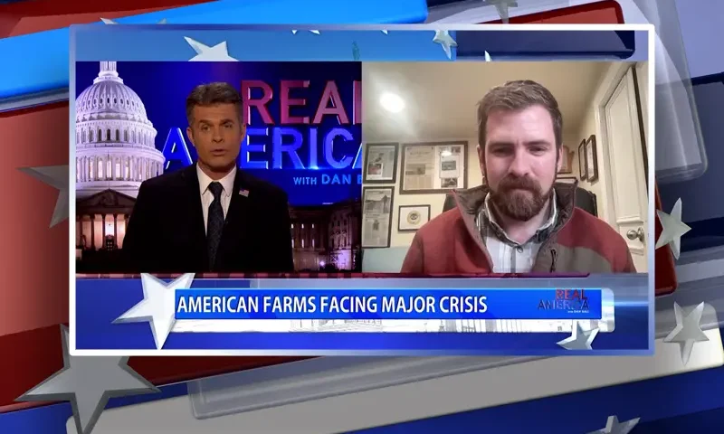 Video still from Real America on One America News Network showing a split screen of the host on the left side, and on the right side is the guest, Brian Reisinger.