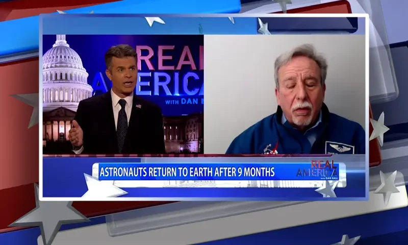 Video still from Real America on One America News Network showing a split screen of the host on the left side, and on the right side is the guest, Charles Camarda.