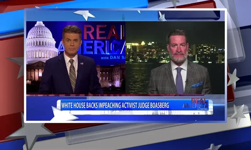Video still from Real America on One America News Network showing a split screen of the host on the left side, and on the right side is the guest, Rep. Greg Steube.