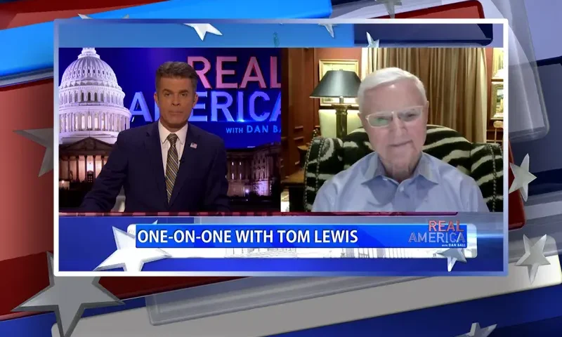 Video still from Real America on One America News Network showing a split screen of the host on the left side, and on the right side is the guest, Tom Lewis.