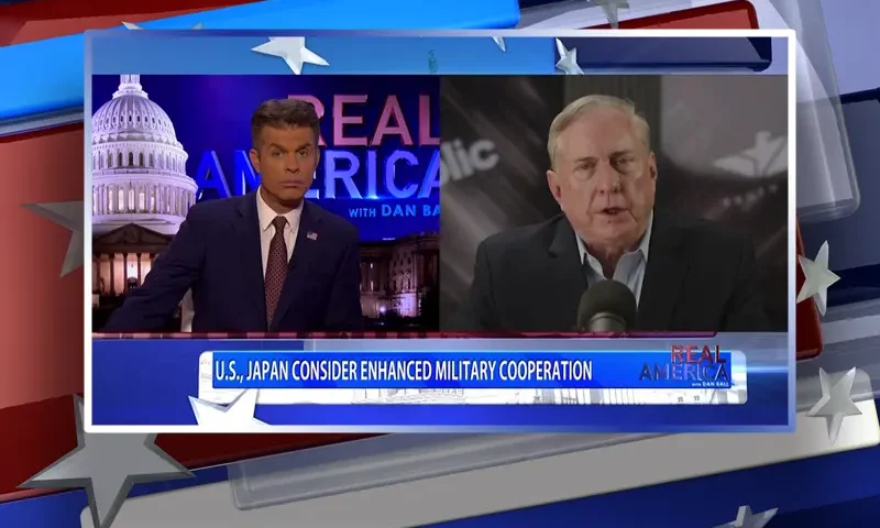 Video still from Real America on One America News Network showing a split screen of the host on the left side, and on the right side is the guest, Col. Doug Macgregor.