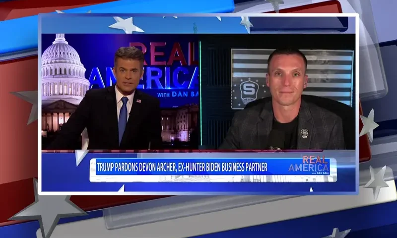 Video still from Real America on One America News Network showing a split screen of the host on the left side, and on the right side is the guest, Steve Friend.
