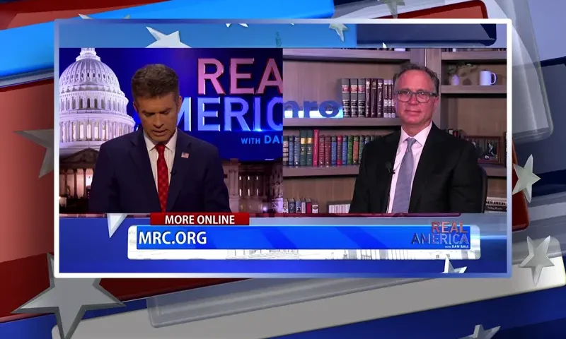 Video still from Real America on One America News Network showing a split screen of the host on the left side, and on the right side is the guest, Dan Schneider.