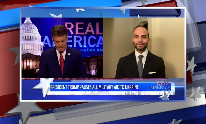 Video still from Real America on One America News Network showing a split screen of the host on the left side, and on the right side is the guest, George Papadopoulos.