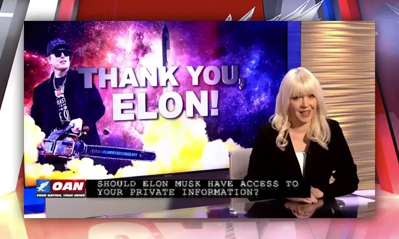 The host sitting at the news desk.