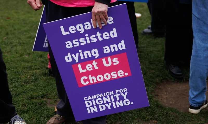 Campaigners in Parliament Square in favour of the proposed bill to legalise assisted dying, on October 16, 2024 in London, England. The 'Terminally Ill Adult (End of Life) Bill' seeks to help terminally ill people with six to 12 months left to live to end their lives legally. As a safeguarding measure, it proposes that a judge and two doctors would need to sign off on a patient's request for an assisted death. A recent poll showed a majority of the public would support assisted deaths for the terminally ill. (Photo by Dan Kitwood/Getty Images)