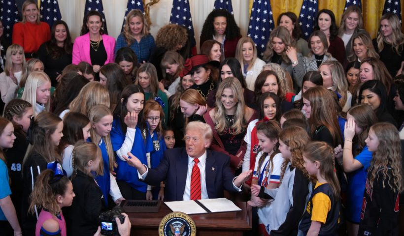 WASHINGTON, DC - FEBRUARY 05: U.S. President Donald Trump joined by women athletes signs the “No Men in Women’s Sports” executive order in the East Room at the White House on February 5, 2025 in Washington, DC. The executive order, which Trump signed on National Girls and Women in Sports Day, prohibits transgender women from competing in women’s sports and is the third order he has signed that targets transgender people. (Photo by Andrew Harnik/Getty Images)