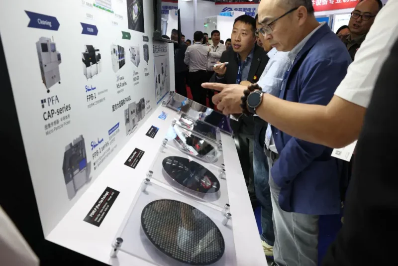 People look at semiconductor products at the SEMICON China semiconductor exhibition in Shanghai on March 26, 2025. (Photo by AFP) / China OUT (Photo by STR/AFP via Getty Images)