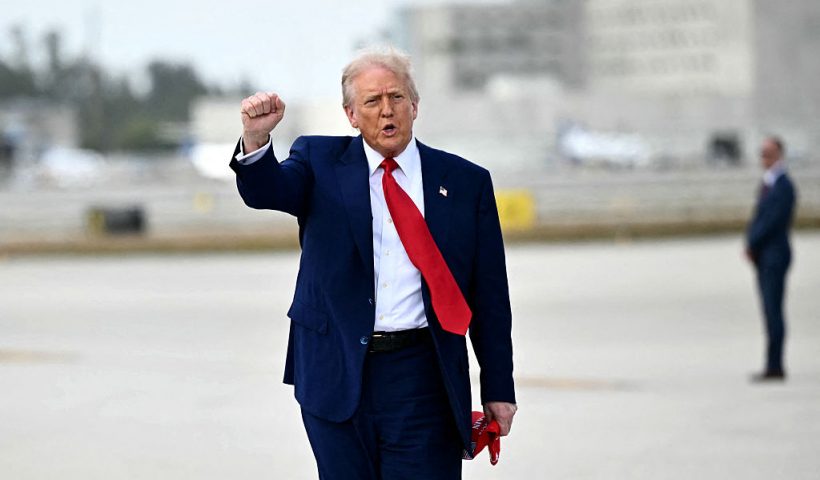 TOPSHOT - US President Donald Trump pumps his fist upon arrival at Miami International Airport on April 3, 2025. Trump is travelling to the Trump National Doral Golf Club before going to his Mar-a-Lago Resort. (Photo by Mandel NGAN / AFP) (Photo by MANDEL NGAN/AFP via Getty Images)