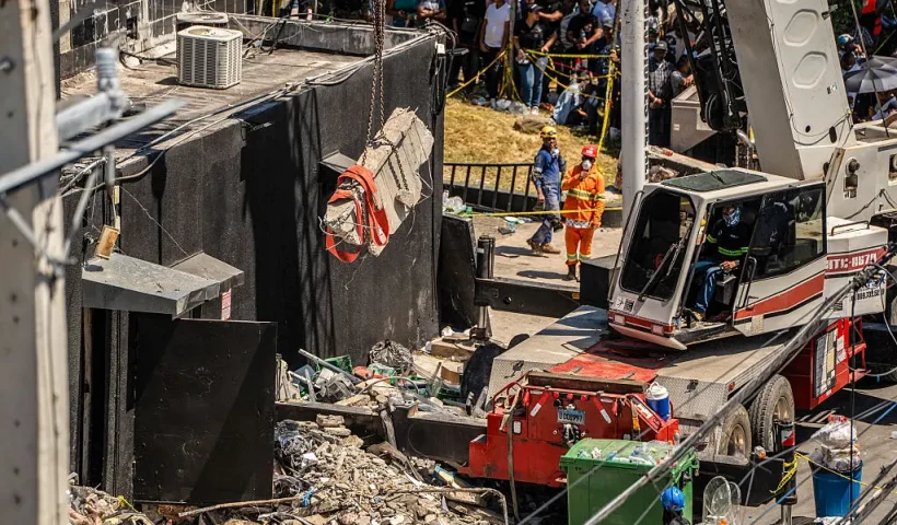 Personnel from civil defense and firefighters work at the Jet Set nightclub following the collapse of its roof in Santo Domingo on April 8, 2025. Rescuers raced to find survivors Tuesday among the rubble of a Dominican Republic night club where at least 44 people died and dozens were hurt in an early-morning roof collapse. (Photo by Francesco SPOTORNO / AFP) (Photo by FRANCESCO SPOTORNO/AFP via Getty Images)
