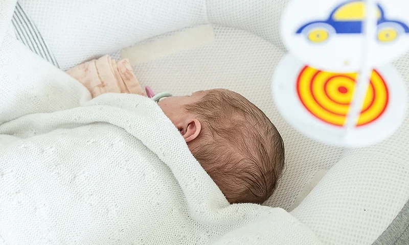 Illustration picture shows and a baby sleeping under a mobile for crib, Monday 21 April 2025, in Sint-Martens-Latem. BELGA PHOTO JAMES ARTHUR GEKIERE (Photo by JAMES ARTHUR GEKIERE / BELGA MAG / Belga via AFP) (Photo by JAMES ARTHUR GEKIERE/BELGA MAG/AFP via Getty Images)