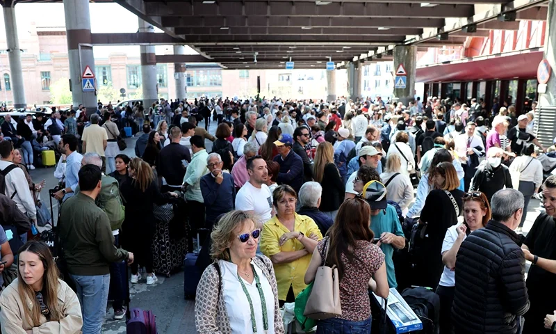 People wait outside the Atocha train station in Madrid after its closure as a massive power outage hits Spain on April 28, 2025. Power went out across all of Spain and Portugal today, cutting cellphone and internet networks, halting trains and trapping people in elevators, officials said. The operator, Red Electrica, said it would likely take six to 10 hours to restore power in the country and urged people not to speculate as to the cause of the outage. (Photo by Thomas COEX / AFP) (Photo by THOMAS COEX/AFP via Getty Images)