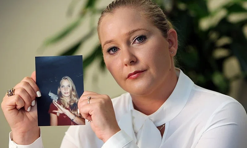 Virginia Roberts Giuffre holds a photo of herself as a teen, when she says she was abused by Jeffrey Epstein, Ghislaine Maxwell and Prince Andrew, among others. (Emily Michot/Miami Herald/Tribune News Service via Getty Images)