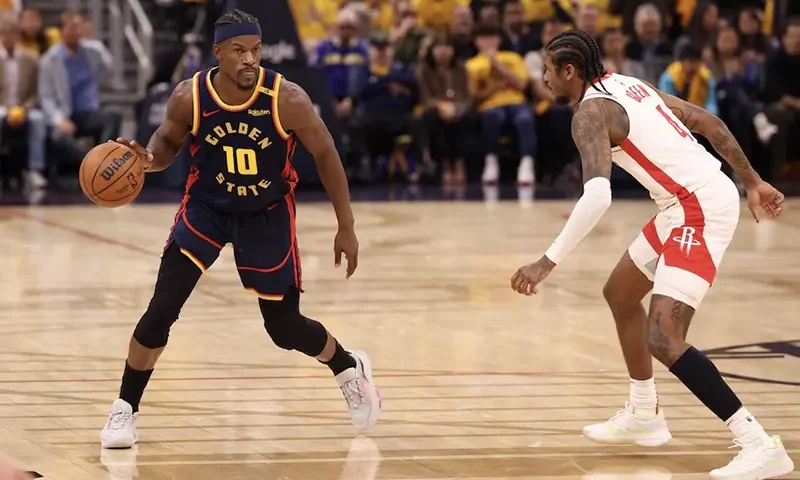 Golden State Warriors forward Jimmy Butler III (10) controls the ball against Houston Rockets guard Jalen Green (4) during the second quarter of game four of the 2025 NBA Playoffs first round at Chase Center. Mandatory Credit: Kelley L Cox-Imagn Images