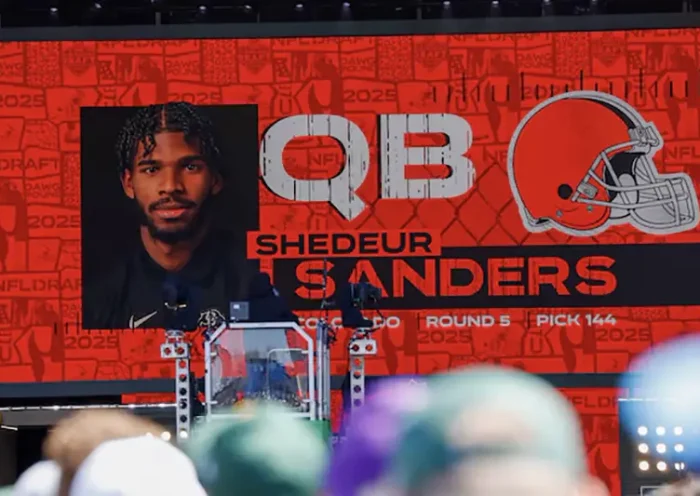 A graphic announcing Colorado quarterback Shedeur Sanders’ selection by the Cleveland Browns with the 144th overall pick is seen in the Draft Theater during the third day of the 2025 NFL Draft at Lambeau Field. Mandatory Credit: Tork Mason/USA Today Network via Imagn Images/File Photo