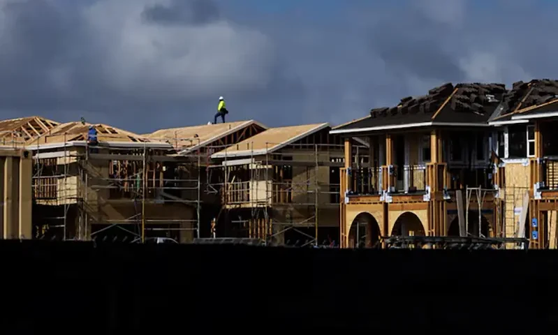A construction worker pauses for a rest as he helps build residential homes in Irvine, California, U.S., March 28, 2025. REUTERS/Mike Blake/File Photo