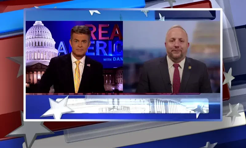 Video still from Real America on One America News Network showing a split screen of the host on the left side, and on the right side is the guest, Rep. Russell Fry.