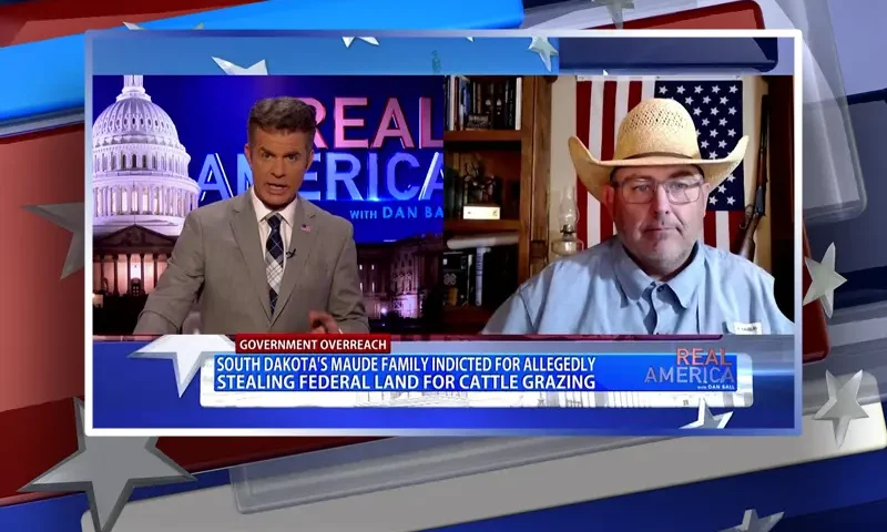 Video still from Real America on One America News Network showing a split screen of the host on the left side, and on the right side is the guest, Shad Sullivan.
