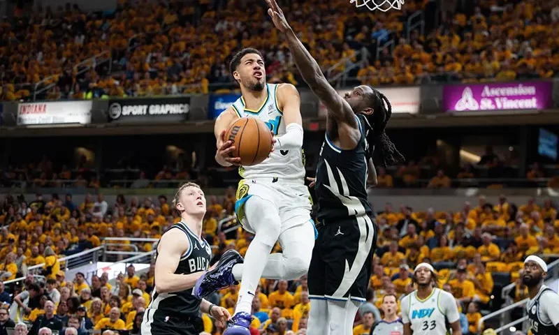 Indiana Pacers guard Tyrese Haliburton (0) shoots the ball while Milwaukee Bucks forward Taurean Prince (12) defends during game five of the first round for the 2024 NBA Playoffs at Gainbridge Fieldhouse. Mandatory Credit: Trevor Ruszkowski-Imagn Images