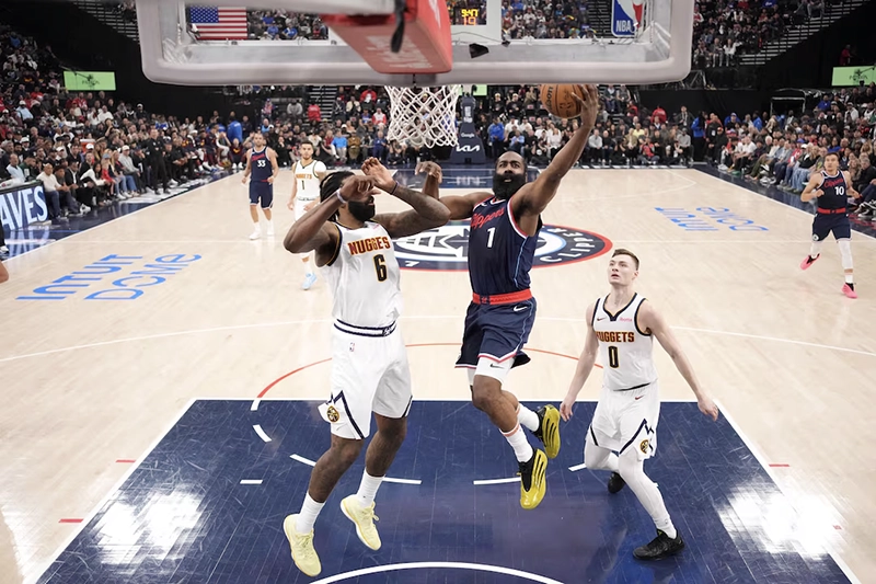 LA Clippers guard James Harden (1) shoots the ball against Denver Nuggets center DeAndre Jordan (6) and guard Christian Braun (0) in the first half during game six of first round for the 2025 NBA Playoffs at Intuit Dome. Mandatory Credit: Kirby Lee-Imagn Images