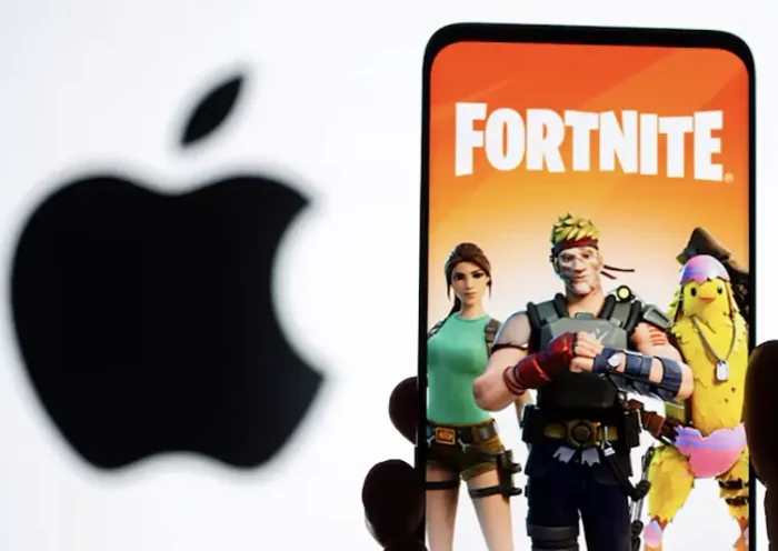 Fortnite game graphic is displayed on a smartphone in front of Apple logo in this illustration created on May 2, 2021. REUTERS/Dado Ruvic/Illustration/File Photo