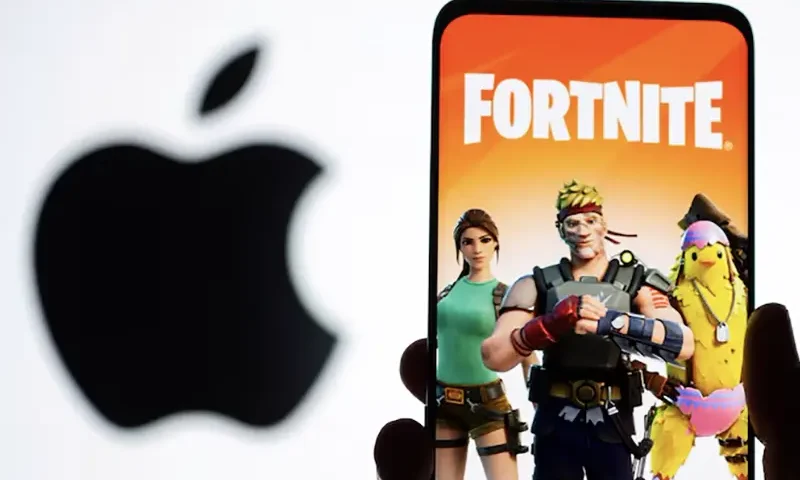 Fortnite game graphic is displayed on a smartphone in front of Apple logo in this illustration created on May 2, 2021. REUTERS/Dado Ruvic/Illustration/File Photo