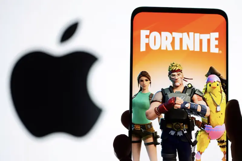 An illustration showcasing the Fortnite game on a smartphone in front of the Apple logo, created on May 2, 2021. REUTERS/Dado Ruvic/Illustration/File Photo
