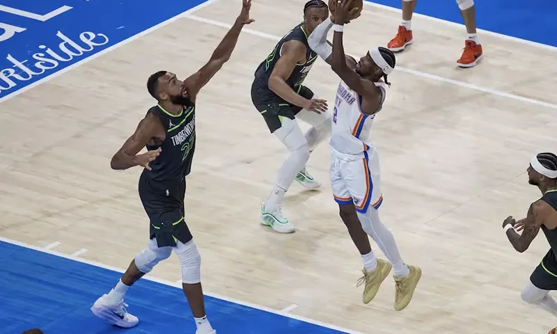 Oklahoma City Thunder guard Shai Gilgeous-Alexander (2) shoots against Minnesota Timberwolves center Rudy Gobert (27) in the third quarter during game one of the western conference finals for the 2025 NBA Playoffs at Paycom Center. Mandatory Credit: Brett Rojo-Imagn Images