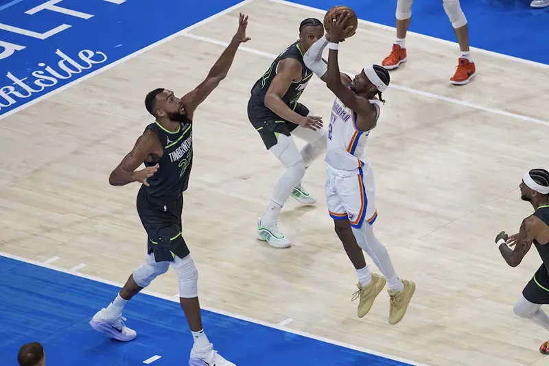 Oklahoma City Thunder guard Shai Gilgeous-Alexander (2) shoots against Minnesota Timberwolves center Rudy Gobert (27) in the third quarter during game one of the western conference finals for the 2025 NBA Playoffs at Paycom Center. Mandatory Credit: Brett Rojo-Imagn Images
