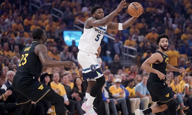 Minnesota Timberwolves guard Anthony Edwards (5) holds onto the ball in front of Golden State Warriors forward Draymond Green (23) in the first quarter during game four of the second round for the 2025 NBA Playoffs at Chase Center. Mandatory Credit: Cary Edmondson-Imagn Images