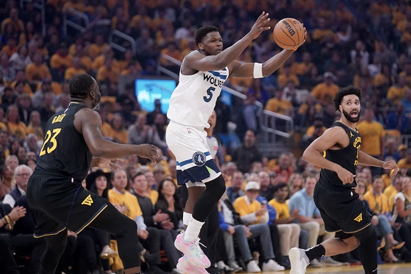 Minnesota Timberwolves guard Anthony Edwards (5) holds onto the ball in front of Golden State Warriors forward Draymond Green (23) in the first quarter during game four of the second round for the 2025 NBA Playoffs at Chase Center. Mandatory Credit: Cary Edmondson-Imagn Images