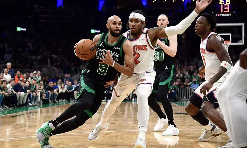 Boston Celtics guard Derrick White (9) controls the ball while New York Knicks guard Miles McBride (2) defends in the second half during game five of the second round for the 2025 NBA Playoffs at TD Garden. Mandatory Credit: Bob DeChiara-Imagn Images