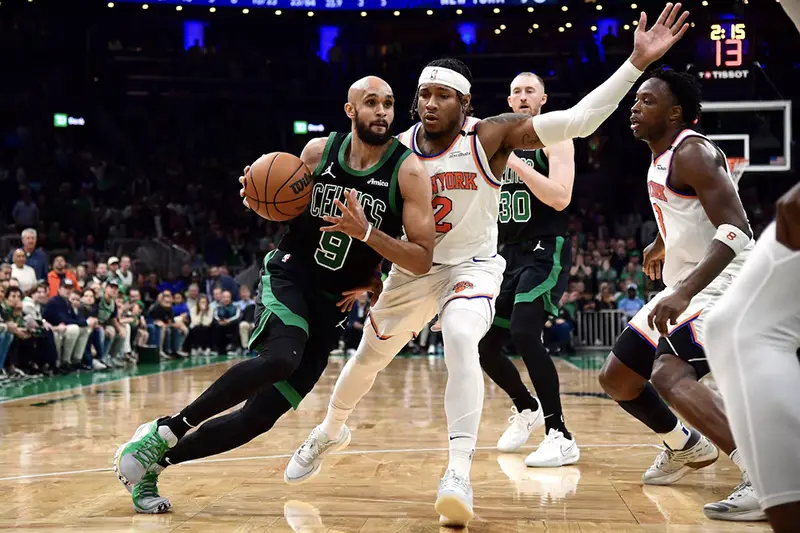 Boston Celtics guard Derrick White (9) controls the ball while New York Knicks guard Miles McBride (2) defends in the second half during game five of the second round for the 2025 NBA Playoffs at TD Garden. Mandatory Credit: Bob DeChiara-Imagn Images