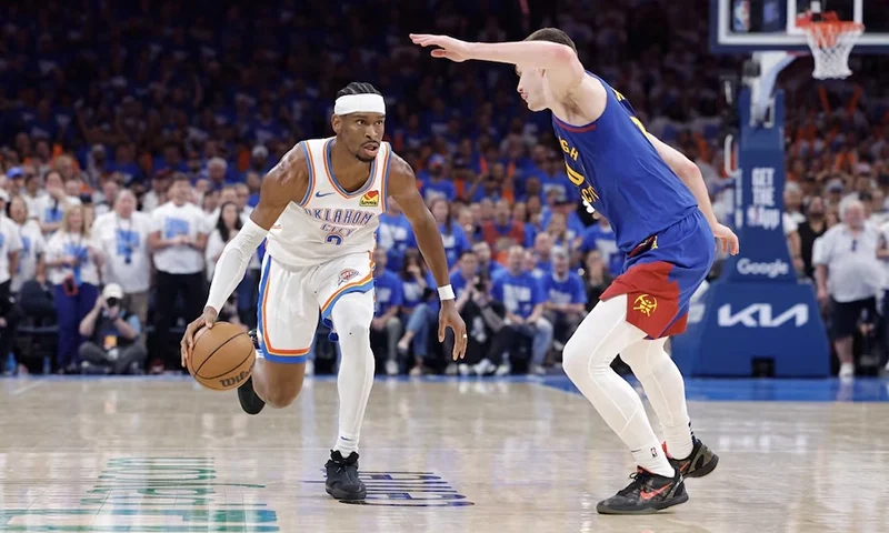 Oklahoma City Thunder guard Shai Gilgeous-Alexander (2) drives down the court beside Denver Nuggets guard Christian Braun (0) during the second half of game five of the second round for the 2025 NBA Playoffs at Paycom Center. Mandatory Credit: Alonzo Adams-Imagn Images
