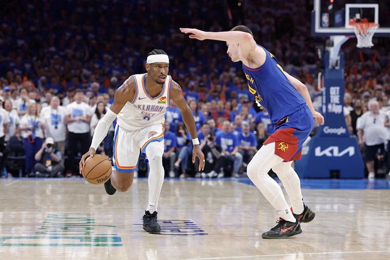 Oklahoma City Thunder guard Shai Gilgeous-Alexander (2) drives down the court beside Denver Nuggets guard Christian Braun (0) during the second half of game five of the second round for the 2025 NBA Playoffs at Paycom Center. Mandatory Credit: Alonzo Adams-Imagn Images