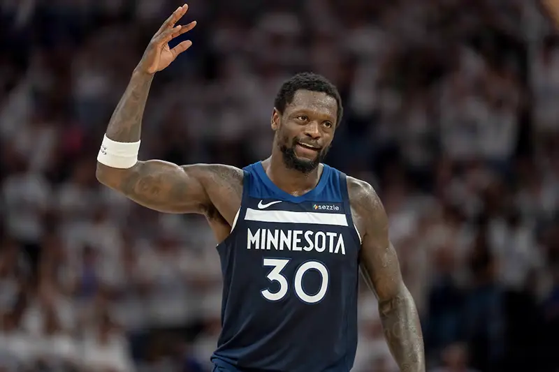 Minnesota Timberwolves forward Julius Randle (30) raises his arm to pump up the crowd after making a shot against the Golden State Warriors in the first half during game five of the second round for the 2025 NBA Playoffs at Target Center. Mandatory Credit: Jesse Johnson-Imagn Images